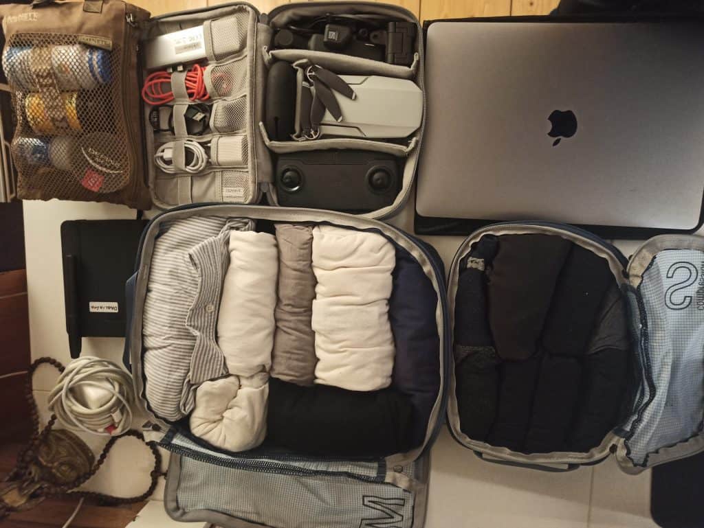 everything in the carry-on only packing list laid out: macbook, packing cubes, toiletries, and the electronics