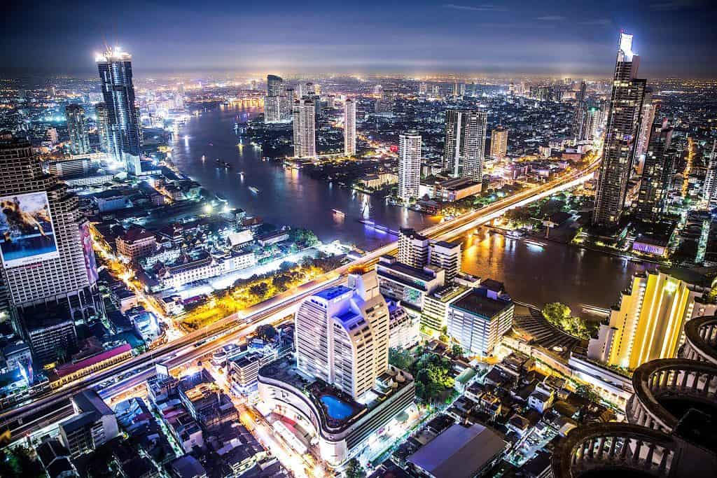 the river in Bangkok lit up at night