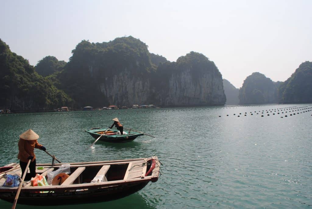 fishermen in Ha Long Bay with a view in the background